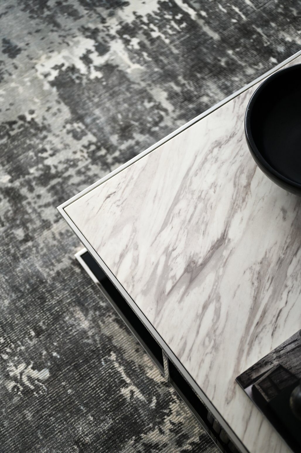 Marble table detail over a textured rug